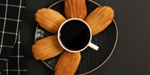 Des madeleines au café autour d'une tasse de café
